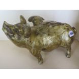 A cast iron flying pig money box with gold paint finish, length 33cm, weight 22cm