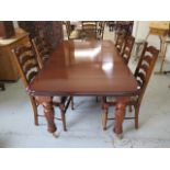 A mahogany effect 19th century style pullout dining table with one leaf and six ladder back dining