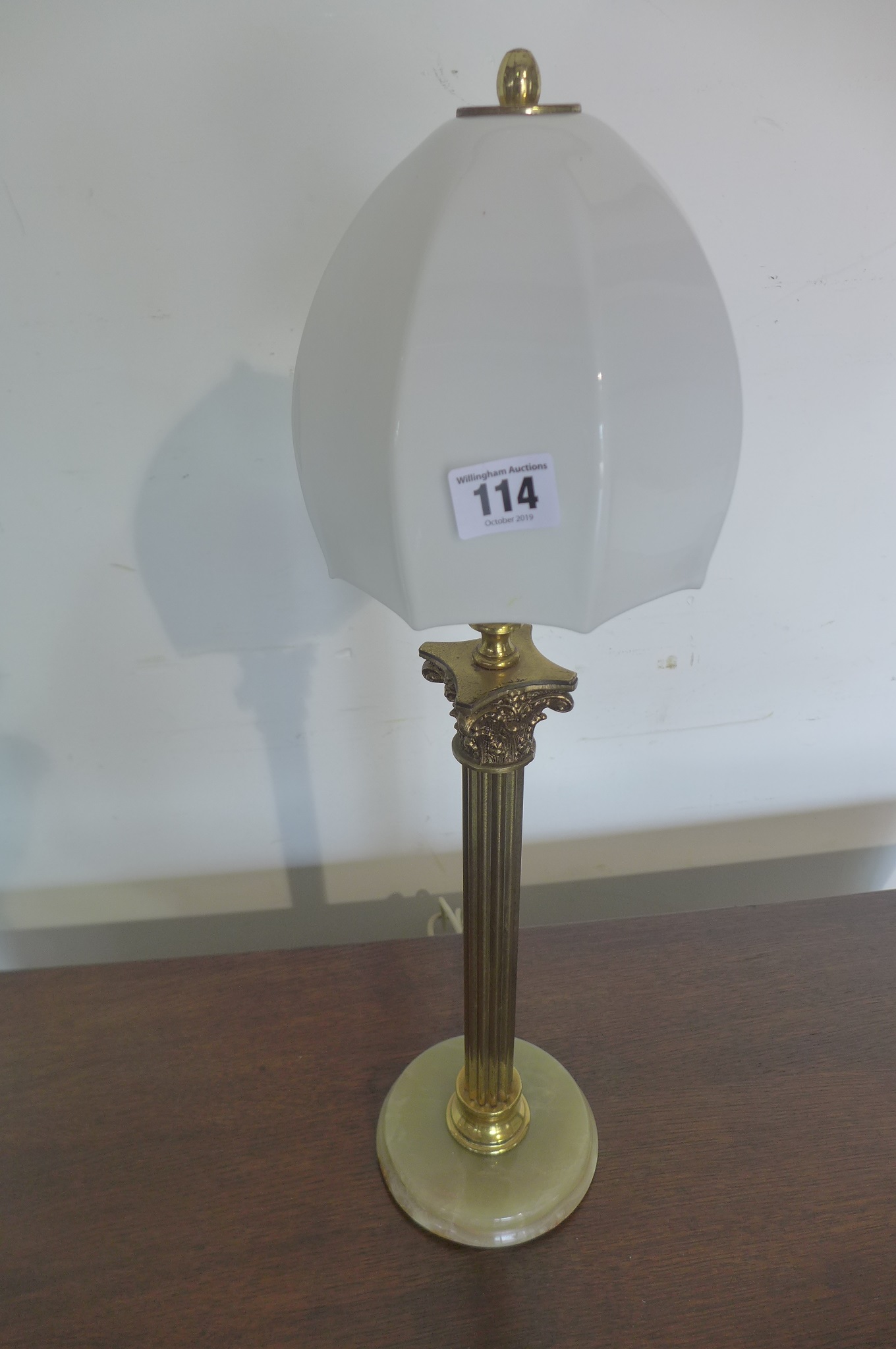 A vintage brass column table lamp with onyx base, tested, 57cm tall