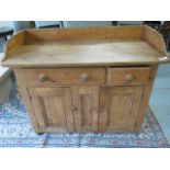 A 19th century pine dresser with a galleried back, above two drawers and two cupboard doors, 120cm W