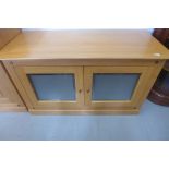 A Multi-York light oak cabinet with two doors, as new, 118cm W x 68cm H