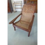 A late 20th century colonial hardwood cane seated planters chair