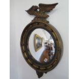 A 1920's mirror with convex glass, the top surmounted with an eagle - 66x47cm in veer good condition