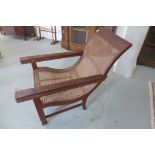 A late 20th century colonial hardwood cane seated planters chair