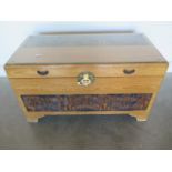 A camphor wood blanket chest with a carved oriental scene to the front panel, in good condition -