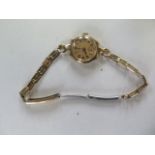 A 9ct gold ladies wristwatch on a plated strap, working, approx total weight 16.5 grams