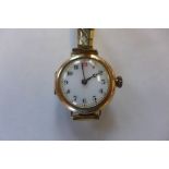 A 9ct yellow gold manual wind wristwatch, on a plated strap, running but damage to case, total
