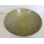 A Chinese olive-green Celadon bowl, 19cm diameter, glaze firing fault otherwise good