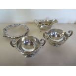 A pair of silver twin handled bowls and a silver sauce boat, denting to bowls, sauce boat