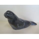 An Inuit carved stone walrus, signed T Narlik, 29cm long