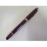 A Montblanc maroon plunger fountain pen with a 4810 14ct nib, 13.5cm long, generally good, not