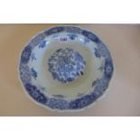 A Chinese 18th century blue and white dish with a raised central boss, decorated with flowers of the