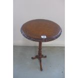 A walnut wine table on a tripod base, 66cm tall, 35cm diameter