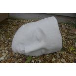 A cast iron stone garden sculpture of a serene sleeping head - 37cm W x 28cm H