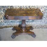 A 19th century fold over card table on a fluted shaped column and quatrefoil platform base, 72cm