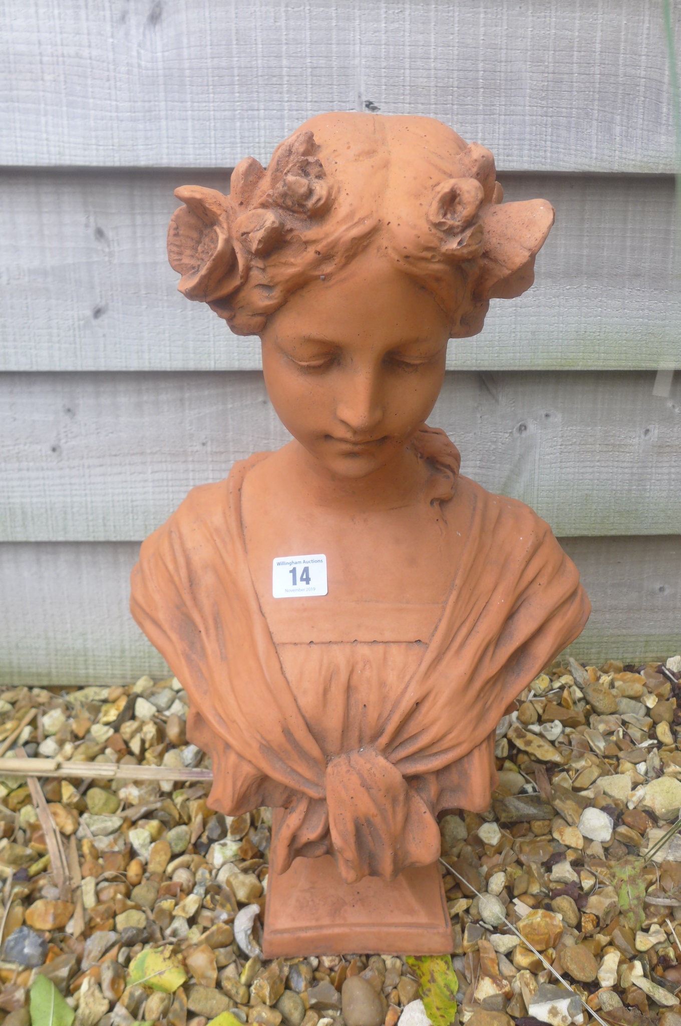 A cast stone Art Nouveau style bust of a young girl with flowers in her hair - 30cm W x 45cm H