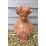 A cast stone Art Nouveau style bust of a young girl with flowers in her hair - 30cm W x 45cm H