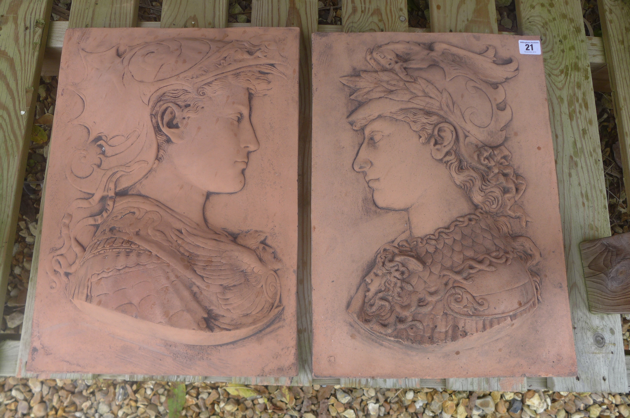 A pair of Renaissance style terracotta garden wall plaques depicting two helmeted gods - 46cm H x