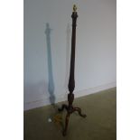 An Edwardian mahogany standard lamp with shaped and reeded column enhanced with carved wheaters, all