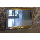 A gilt swept mirror - 76x106cm