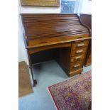 An oak single pedestal four drawer roll top desk, 116cm tall x 105cm x 77cm