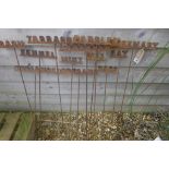 A set of twelve wrought iron garden herb name markers, 88cm H