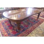 A Victorian wind out mahogany dining table with two leaves, on turned carved fluted legs, 73cm