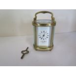 A J W Benson brass carriage clock, oval in shape, white enamel face, 8.5cm H, 6.2cm Wide, running,