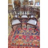 A set of eight 20th century mahogany dining chairs with entwined vase shaped splats on cabriole