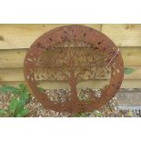 A pierced steel decorative circular wall panel depicting the Tree of Life with snails, 58.5cm