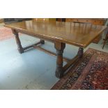 A 20th century oak refectory table on turned supports, with a carved frieze, 77cm tall x 107cm x