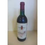 A bottle of 1977 Montagne St Emilion red wine - level to base of neck