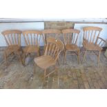 A set of six beech wood dining kitchen chairs, including a carver