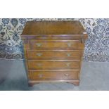 A 19th century style walnut bachelors chest with a fold over top above four long drawers, 73cm