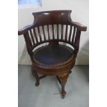 An early 20th century mahogany swivel desk chair with a padded seat, 88cm H x 61cm W