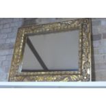 An ornate carved gilt mirror 79x101cm