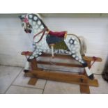 A wooden painted Collinson rocking horse purchased Christmas 1973 from Joshua Taylors of