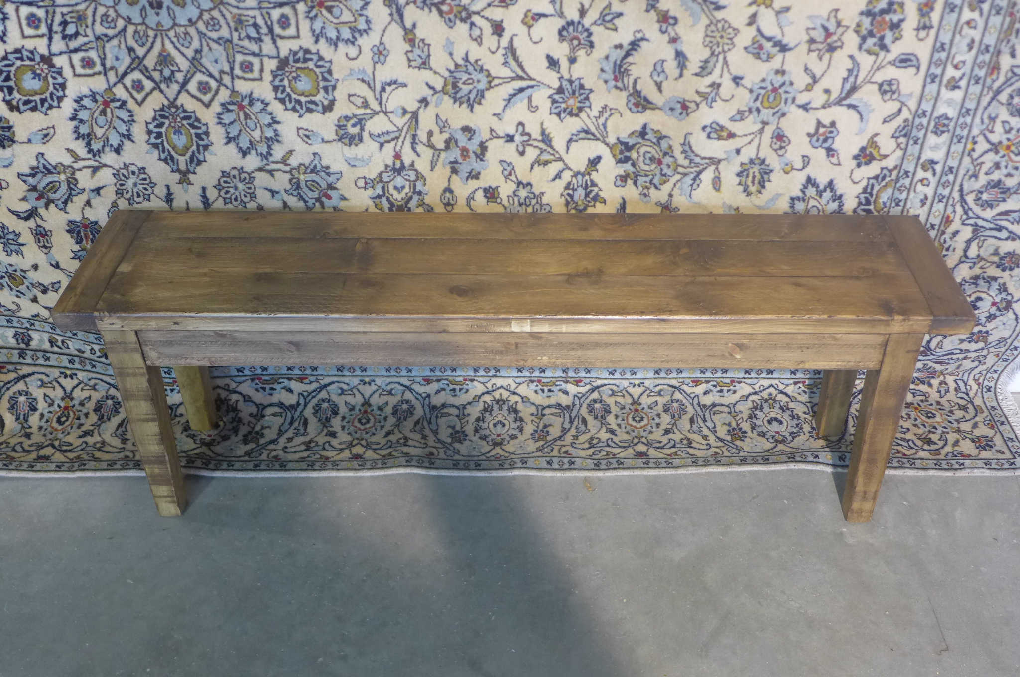 A rustic pine bench 48cm tall x 143cm x 32cm