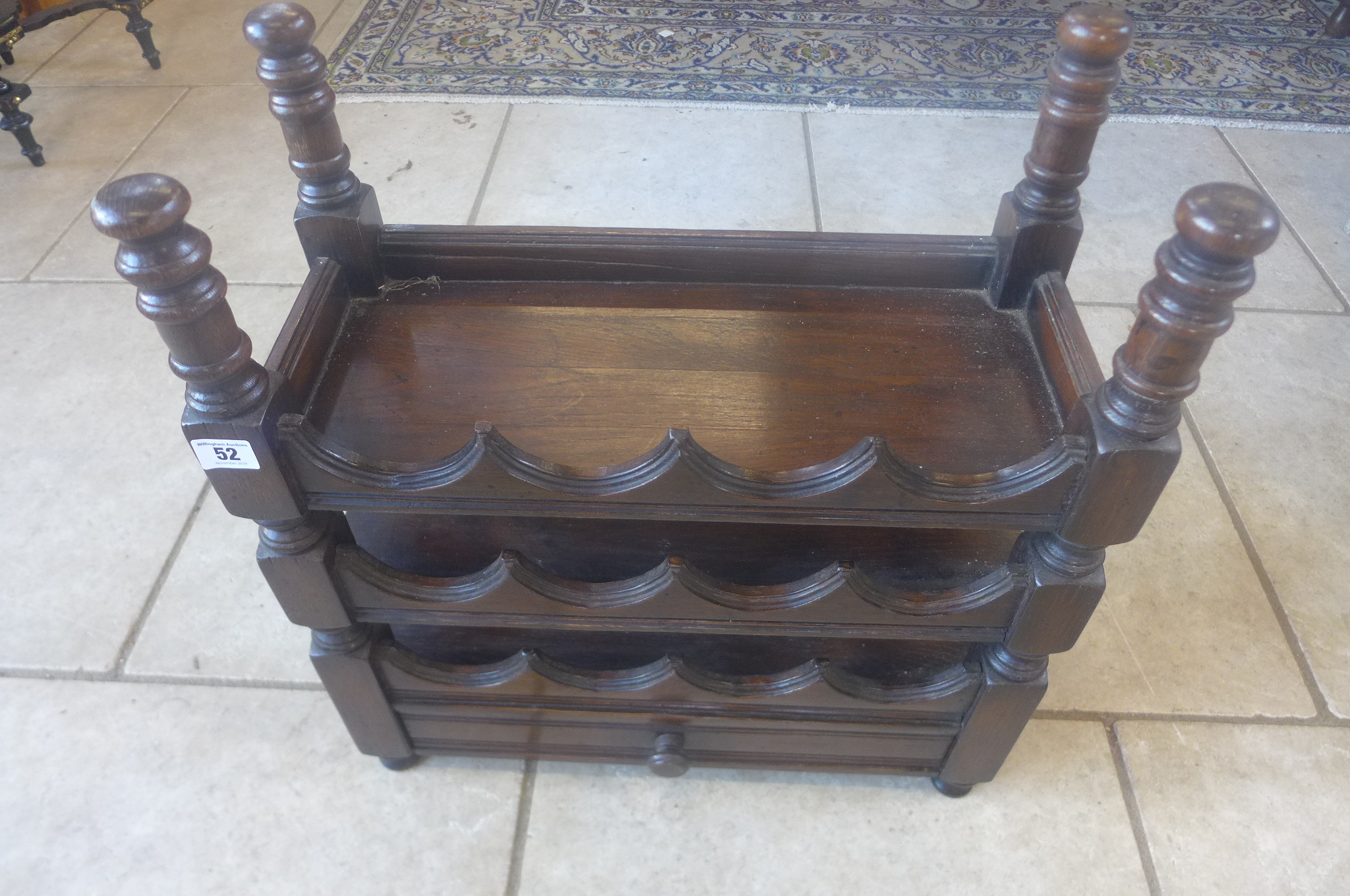 An oak twelve bottle wine rack with a drawer, 57cm tall x 52cm x 24cm