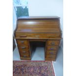 A Hamilton MFC and Co oak seven drawer roll top desk with slides, 112cm H x 107cm x 68cm