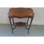 An Edwardian mahogany side table with a shaped top and under tier 71cm H x 62cm x 40cm