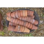 A quantity of vintage terracotta plant pots, each 9cm high in a vintage galvanised bath, 65cm W,