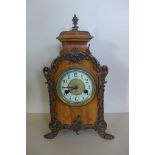 A German 14 day mantle clock, striking on a gong with ormulu decoration, 39cm tall, running