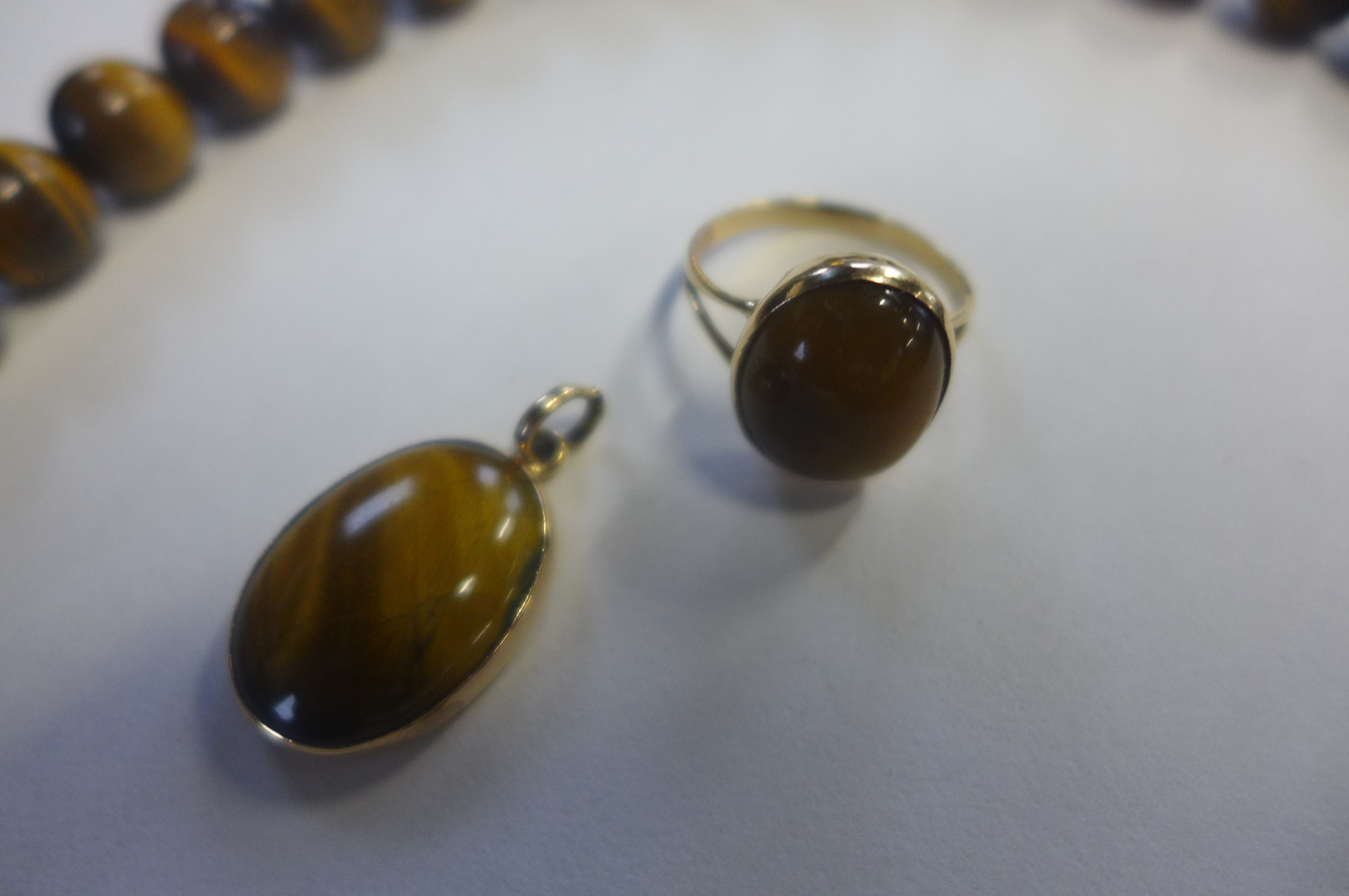 A gold and tigers eye pendant, gold and tigers eye ring, tested as 18ct, pendant measures 12mm in - Image 2 of 3