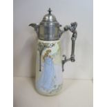 An Art Nouveau ceramic claret jug with a plated top and handle, marked RC and Co, 28cm tall,