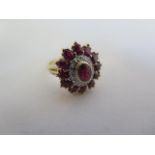 A pretty ruby and diamond ring in 14ct yellow gold, set with a central ruby of 5mm x 4mm approx,