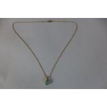 An untreated Columbian emerald, in an 18ct mount and chain, stone measures approx 9 x 7 x 4.5mm