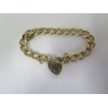 A 9ct gold heavy curb link bracelet with heart shape clasp, length 20.5cm, approx 24.4 grams,