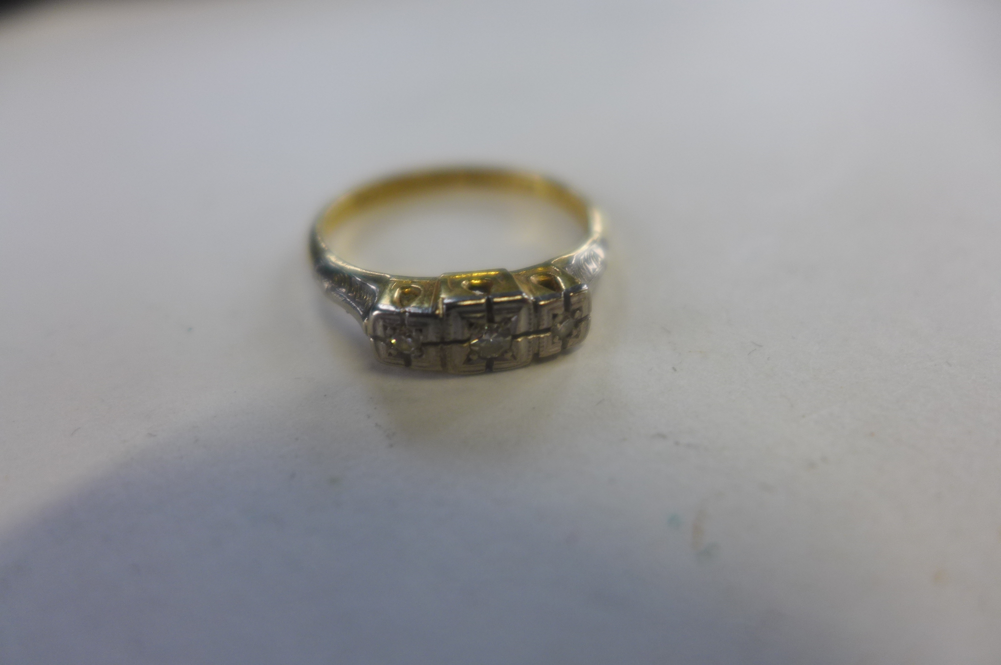 An 18ct platinum three stone diamond ring, size L, approx 2.8 grams, marked 18ct plat