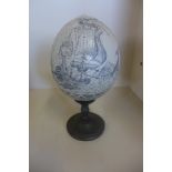 An unusual Scrimshaw Whaling scene Ostrich egg on a stand, total height 21cm, old repair to base